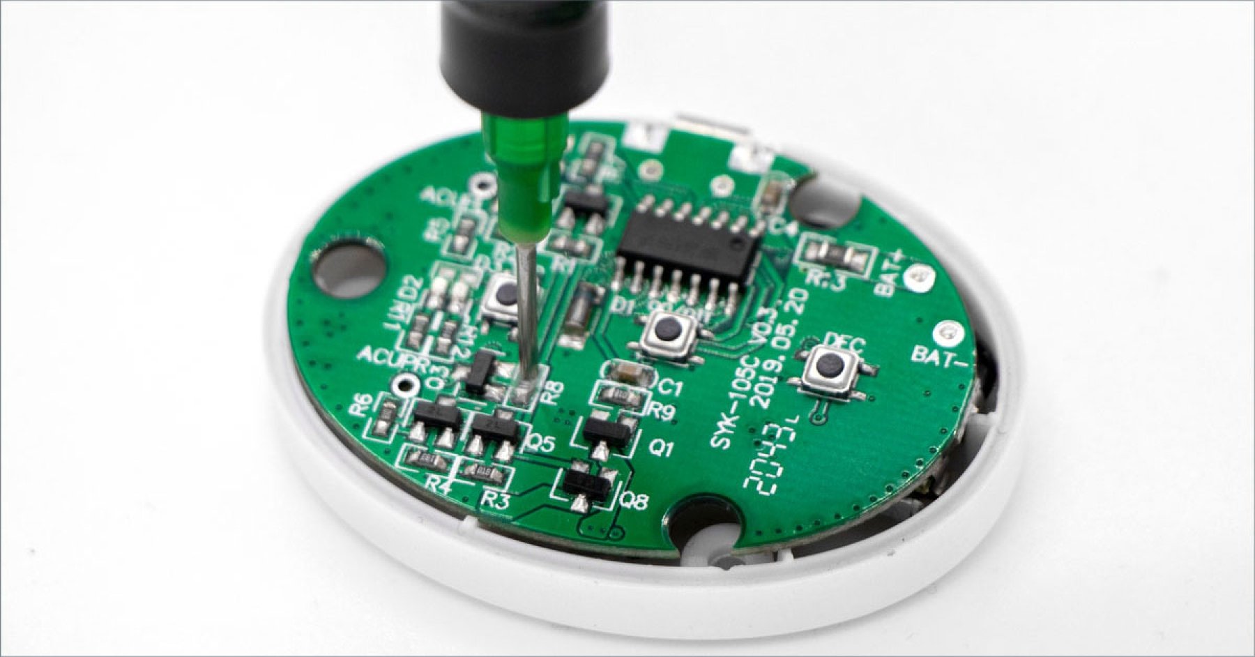 A Dymax light-curable encapsulant is dispensed onto a wearable electronics printed circuit board.